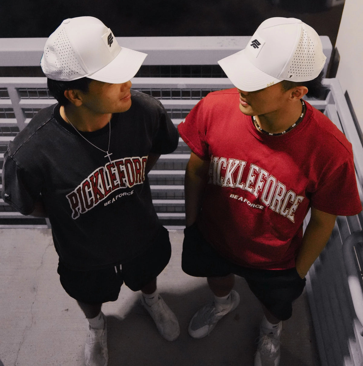 Two guys repping Pickleforce streetwear attire, black and red shirt